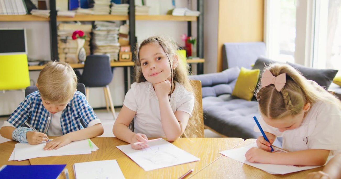 a group of children sitting at a table